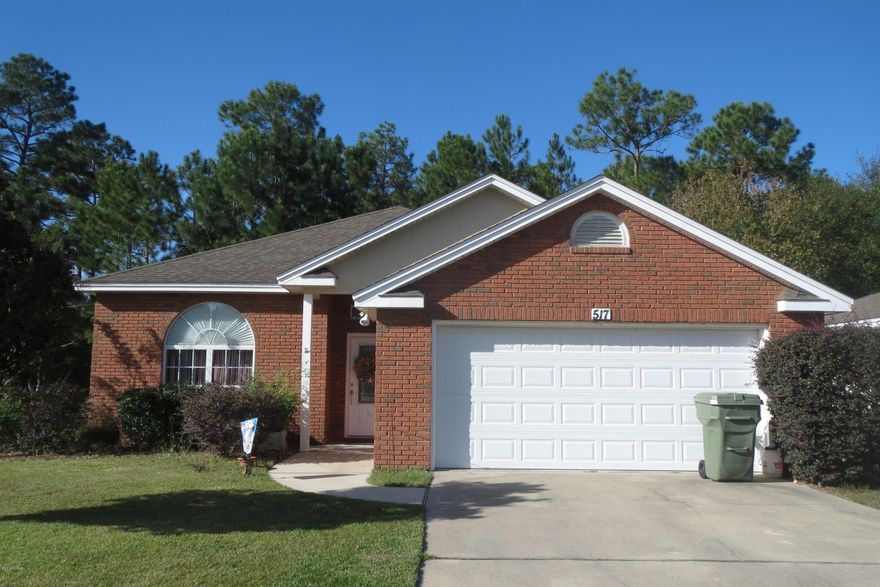 BEAUTIFULLY MAINTAINED HOME IN THE DESIRABLE TIMBERS SUBDIVISION!  Centrally located in Lynn Haven, this  home features a spacious living room with a fireplace, a dining area off the kitchen with a breakfast bar and loads of over-sized cabinets, and a Master bedroom with trey ceilings.  The Master bath has a double vanity, large shower and a walk-in closet.  Through the dining area's French doors, you will step onto the covered patio with an extended lanai area that overlooks the fenced yard and a yard building for additional storage.  the yard actually extends beyond the fence line, if you need a little more space.  This home is a must see in this price range!