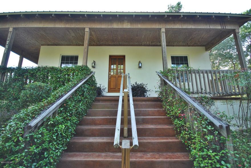 3600 square feet under roof, 1872 square feet heated and cooled, three bedrooms / three bathrooms.

Picturesque views abound from this Rosemary Beach-style Coastal Craftsman inspired masterpiece right across the street from Lake Powell. Homes of this magnitude are rarely exposed to the market & artfully combines contemporary design with classic naturalist architecture indicative of Lake Shore Estates & its beautiful surroundings. Positioned in the most desirable area of Inlet Beach, this Lake Shore Estates home is perched at one of the highest elevations in Inlet Beach.  The individualized architectural detailing of this home is evident as soon as you walk in the front door as you are greeted with an open and airy living space with ten foot ceilings. The summer kitchen is absolutely amazing with premium appliances and a center island for enhanced space utilization
The master bedroom is spacious with a large walk in closet and large master bath with tile floors and cultured marble counters. Guest bedroom is spacious with a large bath with Jacuzzi tub. The third bedroom is currently being used as an office but could be converted to a bedroom. Home also has a large laundry room with a handicapped accessible full size bath. Entire home has great natural light with large windows throughout. Double insulation and storm windows for the energy conscious buyer. An oversized garage also provides work space and additional storage. The home was built with great care and with attention to detail and has been beautifully maintained. This property makes a beautiful year round home or a great periodic vacation home. The lot is over a half-acre and is large enough for an in ground pool or a guest cottage. 
Here are some of the custom features of the home:
- yellow pine hardwoods in main living area
- ten foot ceilings throughout the home
- seven foot Spanish cedar doors
- built-in china cabinet in dining room
- built in cabinets and desk in office
- matching cabinets, center island, and quartz countertops in kitchen
- Kitchen has large island cook top with a large breakfast bar for casual dining
- 782 square feet of stained and polished concrete porches
- 900 square foot 2.5 car garage with room for golf carts or watercraft
- ADT security system
-  surround sound
- 3/4 inch stucco
Enjoy the benefits of a community fishing dock on Lake Powell right across the street, and a "Blue Wave Beach" access just down the road (approximately a half-mile ) to the south of the property, you are only minutes away from enjoying the many watersport activities the area has to offer.
Here are all of the amenities and activities available within one mile:
- Lake Powell 
- Gulf of Mexico 
- Shopping and fine dining at 30Avenue, Rosemary Beach retail shops, and spas to cater to your needs. 
- walking distance to the Donut Hole Restaurant and Shades Restaurant