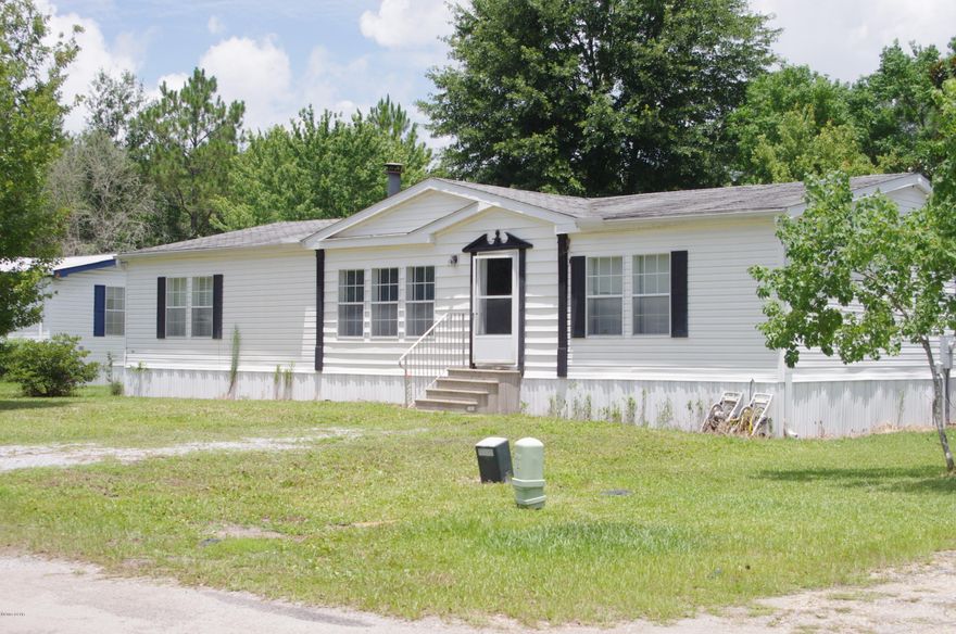 Freshly Paved Road and Close to Tyndall, this 3 bed room, 2 bath Double Wide Mobile Home with wood burning fireplace, would make a good first home. Large pantry, built in cabinets and laundry room. Washer and Dryer also convey in sale.Bank says bring offer!