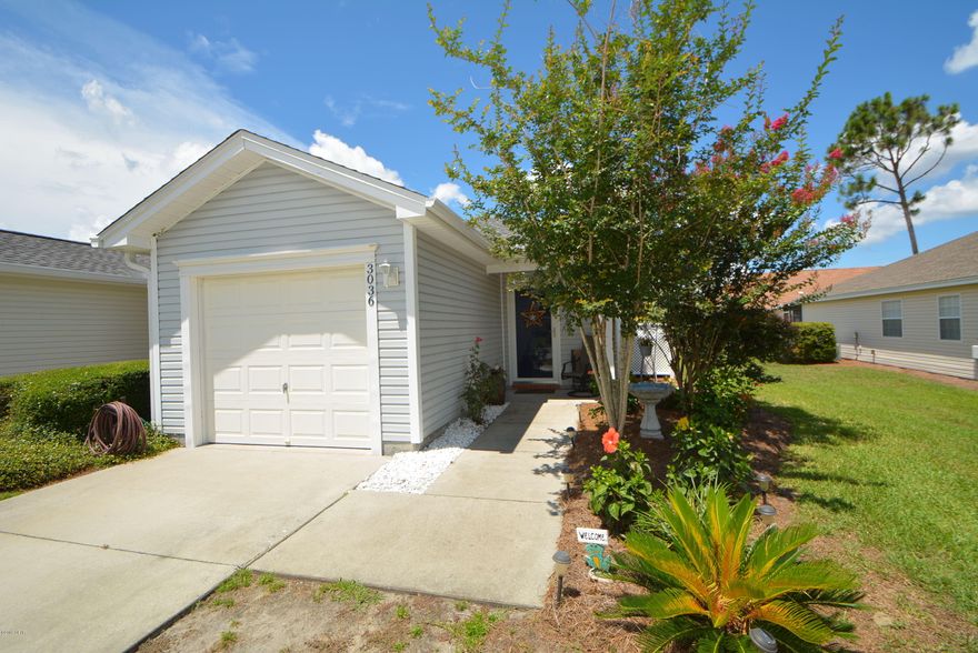 Fantastic townhouse in the always desirable Hammocks subdivision and lots of improvements in this unit including a new roof, new water heater, wood floors, stainless appliances and more. You will appreciate the open floor plan the moment you enter the home. The end unit has lots of natural light through the windows with plantation shutters, There is a dining area  and open and bright kitchen. The enclosed sun room is heated and cooled an overlooks the charming paver patio  out back and is a great place for reading or crafts with all the natural light. There is also a single car attached garage. The HOA dues cover the cost of the lawn care and sprinkler system as well. In addition, you have the use of the community pool.