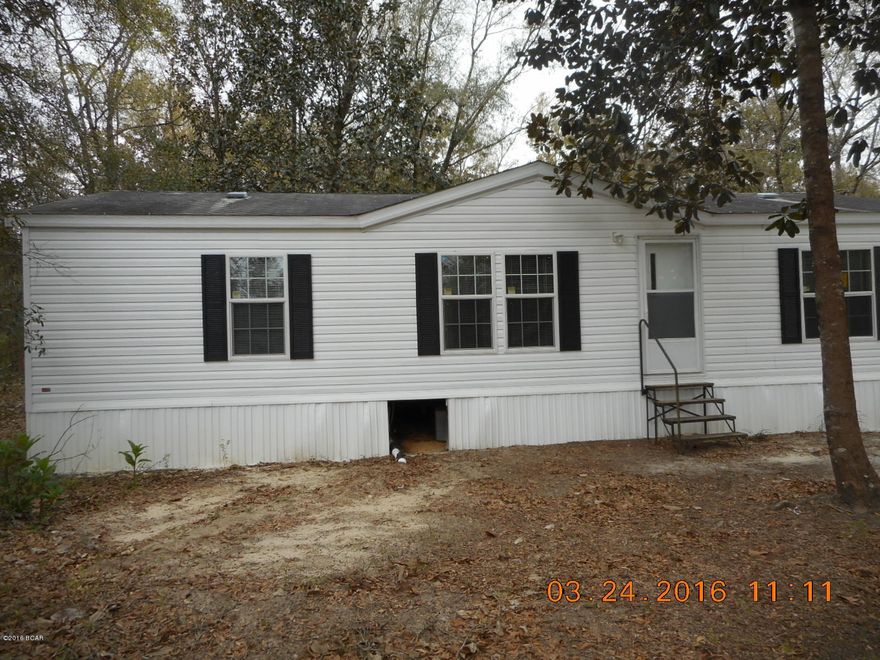 Freshly painted interior and looks like new inside and out.  This mobile home is conveniently located near Hwy 20 and Bruce and a short drive to beaches from here.  It is located down a private drive which is away from the hustle and bustle.  Mobile home has new carpeting throughout. Large deck on back side.  

NOTE: There is no well on this property.  Well was shared with neighbor who was a family member.