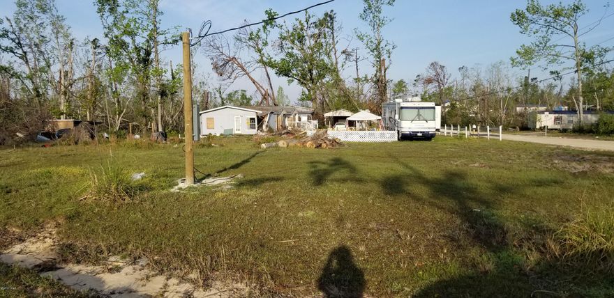 Bring us an offer! Nice corner lot with power and well. Septic tank in place but not guaranteed. This lot is a little over an acre and a half and would make a nice place to build your new home or bring in your own mobile home and set up. Mobile home is being left at the convenience of the seller will not be removed. No value in the mobile home.