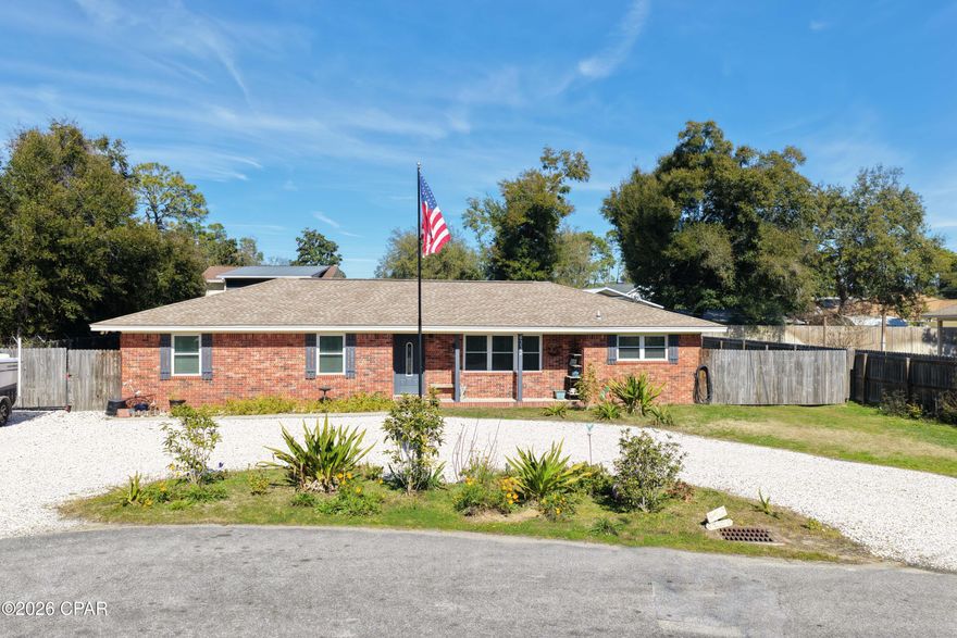 Well-maintained 3-bedroom all-brick home on two oversized lots!  Ideally located at the end of a quiet dead-end street in Panama City Beach, you are also close to St. Andrews State Park, the Navy base, Bay Point Golf Course, and just minutes to beaches, shopping, and dining.  Recent updates include a new roof, septic tank, and windows. The open-concept floor plan is perfect for everyday living, while the fenced backyard shines with a she-shed, 20x35 detached carport with workshop, RV hookup with outlet, and plenty of room for a pool and all your toys. No HOA and short-term rentals allowed — rare find with endless possibilities! Call today and make this your next home or investment in Panama City Beach!!
