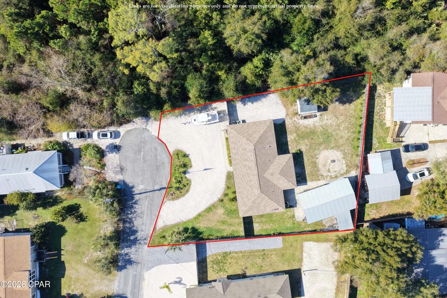 Well-maintained 3-bedroom, single story,  all-brick home on two oversized lots!  Ideally located at the end of a quiet dead-end street in Panama City Beach, you are also close to St. Andrews State Park, the Navy base, Bay Point Golf Course, and just minutes to beaches, shopping, and dining.  Recent updates include a new roof, septic tank, and windows. The open-concept floor plan is perfect for everyday living, while the fenced backyard shines with a she-shed, 20x35 detached carport with workshop, RV hookup with outlet, outdoor shower, and plenty of room for a pool and all your toys. No HOA and short-term rentals are allowed -- rare find with endless possibilities! Call today and make this your next home or investment in Panama City Beach!!