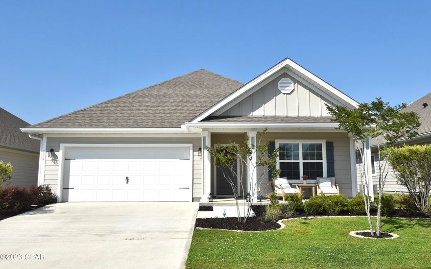 Welcome home to the Villages of Mill Bayou with a gorgeous community pool. This like-new home is centrally located to Tyndall AFB and the Naval base, as well as great public schools, to include two charter schools with one of them in walking distance, and only minutes to shopping and dining. This 4 BR 2 BA offers many custom features and is ready for your family.  As you enter the home, you notice beautiful board and batten wall molding and custom lighting in the foyer.
The open floor plan of this home makes it great for entertaining with the kitchen overlooking the dining area and living room. The living room is highlighted by 10' and 11' double tray ceilings, crown molding, and recessed lighting. The living room and master bedroom overlook the backyard with a view of the pond. The kitchen is the heart of the home, and offers a large walk-in corner pantry with a custom door, backsplash, island, granite countertops, and stainless steel appliances to include the refrigerator. The dining area off the kitchen leads to the covered back porch and fenced backyard. The owner's suite is highlighted by a 10' tray ceiling. The master bath includes a gorgeous tiled shower with a glass door, garden tub, granite double vanity with 4 center drawers, and a private water closet. The laundry room is highlighted by a custom shiplap accent wall offering cabinetry and clothes hanging area, and comes complete with washer and dryer. Luxury vinyl plank flooring in living areas and carpet in bedrooms.  Home has an attached two car garage with attic storage above. You can relax, grill, or watch your kids or pets play in your fenced backyard from your covered porch.  This home also comes with rolled heavy vinyl hurricane blinds.

The Villages of Mill Bayou is a family friendly neighborhood and has so much to offer! Whether you launch your kayak, fish in the pond, spend time at the gorgeous community pool with fire pit, it's all in walking distance (neighborhood has sidewalks) and you are sure to enjoy the outdoors in this community!  
In 2024 a new grocery shopping center, only approx. ½ mile down the road, should be ready for your convenient shopping trips. This home has it all! Call for your private tour today ... it won't disappoint! Measurements approx; verify if important.