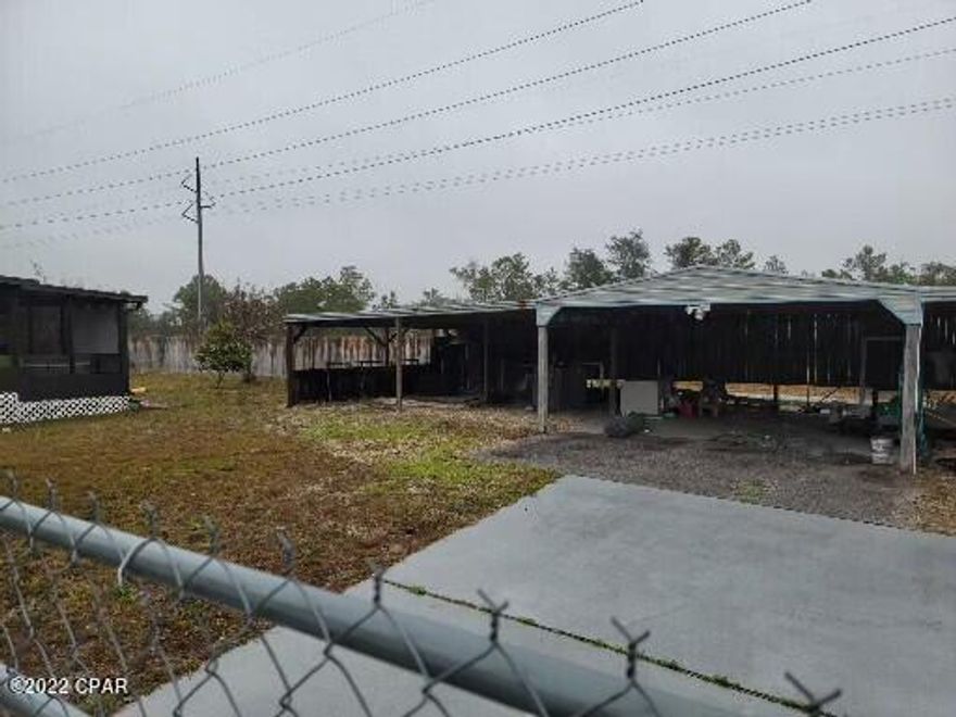 This home has been completely remolded. New floors, ceilings, kitchen appliances Complete finished out. Three bedrooms two full baths. Large covered storage in rear of lot. could park five or six trucks under the shelter.  Large Concrete parking area. This would be great for an independent contractor with a fleet of trucks.