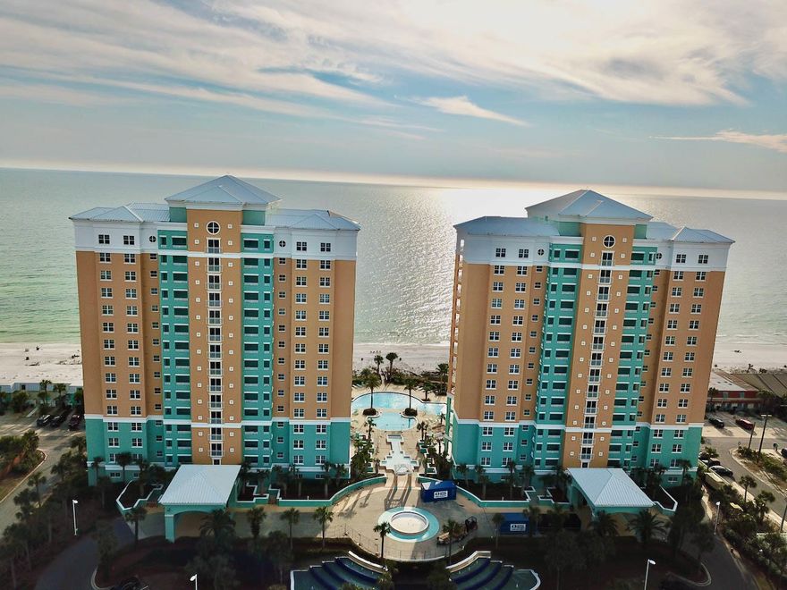 Mediterranean coastal elegance--En Soleil is Panama City Beach's best luxury resort directly on the sugar white sand!   Soak in the sunset on your balcony! This unit is located on the west end of the east tower overlooking the gorgeous Gulf. All walkways and elevators are indoors-no need to worry about getting rained on carrying your groceries! The parking space is under the building with elevator access from parking to your floor- all indoors, and the resort is gated for security. The floor plan has unmatched utility. Enter the home through the grand double doors into the foyer. There are two bedrooms with on suite bathrooms, both offering the serene views of the Gulf! The master bedroom has slider doors opening to the HUGE balcony. There is an oversized laundry room with side by side washer and dryer. Both air conditioners and water heater are new- AC x 2  2020, water heater 2021. Large travertine tile covers the floors in the entire main areas of the unit. The kitchen has beautiful granite countertops and stainless steel appliances, upgraded custom quality cabinets, travertine accents around the breakfast bar, and a waterscape custom backsplash. The master bathroom has modernistic free flowing brushed nickel faucets and a custom, high gloss, waterscape tile backsplash. The bathrooms have decorative back splashes, upgraded tile showers. The master bath has an upgraded custom travertine shower and a jetted tub set in granite casing.   The oversized balcony has terrific space to enjoy entertaining with a built in outdoor grill with counter space and storage!  You won't miss having a backyard in this condo! There is a sizable owner's closet/locker near the front entry. Amenities abound with 24 hr guard and gate security; a Gulf front fitness center; 450 ft of Gulf front, hot tubs and waterfalls; 6500 sq ft of Gulf front pools surrounded by gorgeous patio areas. There are only three units per floor, per building, so no high density. En Soleil is truly a unique Gulf Coast resort experience in Panama City Beach! The location is in the lower traffic portion of Panama City Beach, while just a few miles from the area's best shopping and just down the street from some of the area's best parks and boating. Parking space #7 and owners closet convey.