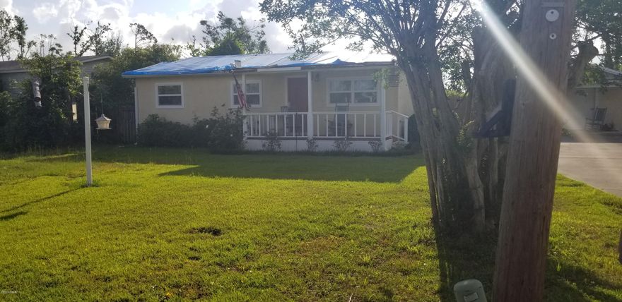 Home was cute as a button prior to Michael, but can be brought back to the way it was. Carpet has been removed from floors ready for new flooring, needs a roof, some sheetrock needs to be removed and remediated in some rooms. New roof over detached garage with window A/C.  Covered porch on the front of the home for those early morning cups of coffee. Some TLC ad this home could be cute once more.