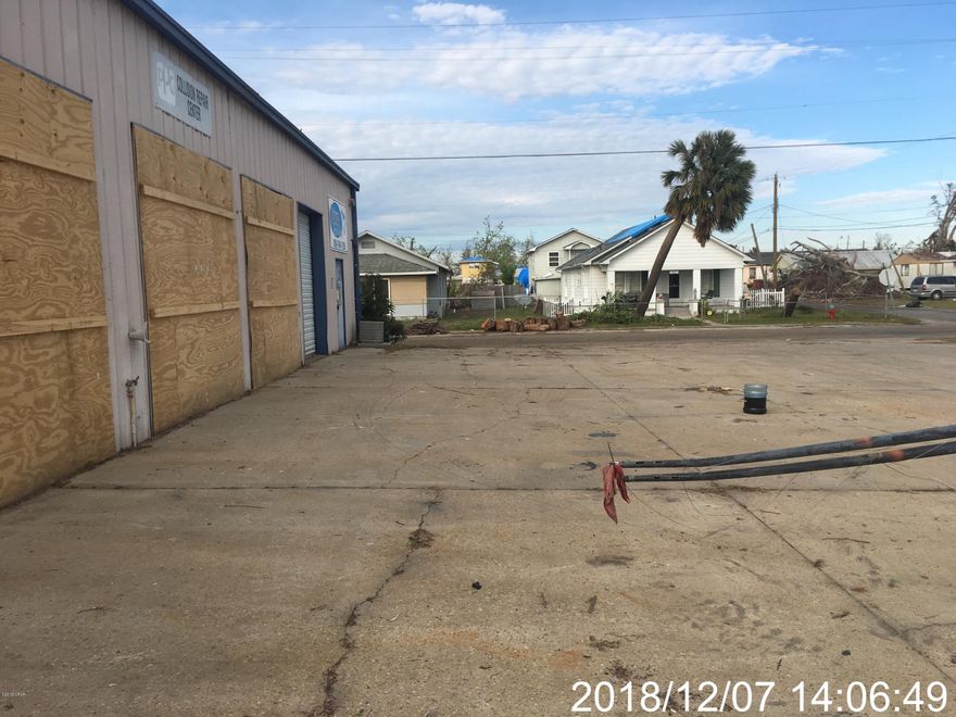 This commercial building sits on a nice corner lot with plenty of parking and yard space. The property was used as an auto body shop with 5 stalls and a paint booth. There is also approximately 430 Sq ft of office space and 2 bathrooms. The workspace has overhead garage doors for both front and back. The yard is chain linked fenced that appears to be 10ft. The front is paved with  plenty of room for parking.