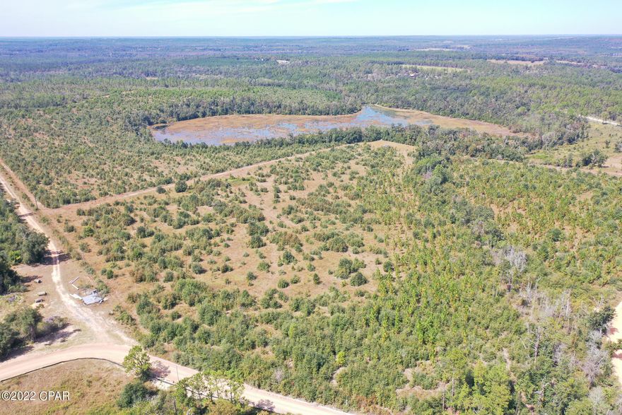 This spacious parcel totals almost 200 acres and is among one of the highest elevations in Florida. It features a large spring fed pond and a creek from the pond that runs throughout the property as well. The timber is made up of longleaf pines, sand pines, cypress, and hardwoods. There's a deep well that was functional with electricity in previous years but its current condition is unknown. The possibilities are endless for this fabulous tract of land! It is an outdoorsman's paradise with many spots for hunting, trail riding, and fishing. You could build your forever country home or a weekend getaway for the family to have gatherings. If you want to live off the grid away from the hustle and bustle, this property is for you and yet it's still accessible to the Panama City area and the World's Most Beautiful Beaches! Listing is for 2 parcels. #00000000-00-0136-0000 and #00000000-00-0134-0002 (adjacent small triangle with road access to Pike Pond Road). Dimensions approximate, buyer to verify if important.