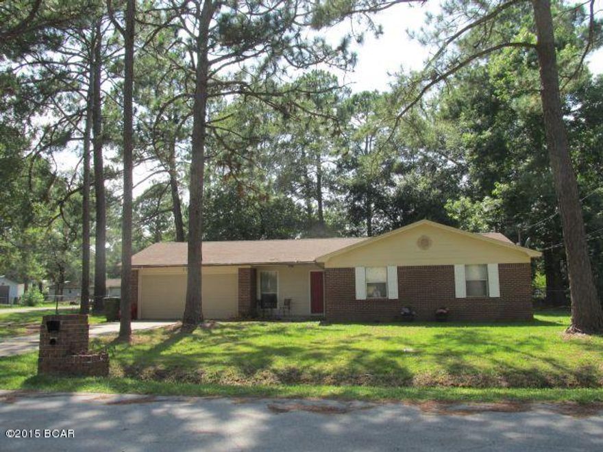 Fantastic buy on this ALL BRICK home in Lynn Haven. Interior painting is in progress and beautiful new Pergo flooring being installed. New wainscoting in Living Room, dining & hallway. Perfect house & large yard for a family with enough space for a future workshop or pool. Easy access double corner lot with chain link-fenced back yard & drive thru gates. Living room has high ceiling, central HVAC, 2-Car Garage has finished interior. Galley-style kitchen is fully equipped. New Stove/oven.  Auto Garage Door opener.  New roof installed recently. Located on a quiet street just minutes away from golf course and public boat landings.