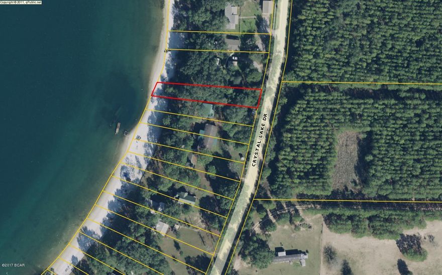 It's called Crystal Lake for a reason! Beautiful crystal clear waters will be at your door steps when you build on this water front lot.  Ready to enjoy Fishing, Boating, Skiing, Kayaking, Paddle Boarding, and Swimming? Being fed by 5 springs, this is some of the best fishing on the planet. These waterfront lots are sought after and don't come along very often. Only minutes from Panama City Beach, Famous Pier Park Shopping,Tyndall Air Force Base, Econfina Springs, Marianna Caverns. Build your Cabin, Dock, Gazebo, or Monster Home. THIS is FLORIDA LIVING ! Bring your offer soon. No HOA's. Come & get it.