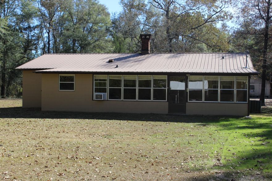 Features of this well kept 3/2 CBS (concrete block structure) home include a spacious Florida room, large utility/laundry room, large pantry, tiled throughout, screened back porch, cozy fireplace, outbuildings for multi purpose, large pole barn and sits on 5 acres. This country setting gives you privacy, glimpses of wildlife’s deer and much more! Plus only a hop n skip to Holmes Creek and Water Management property.   Call today to make your appointment to see!