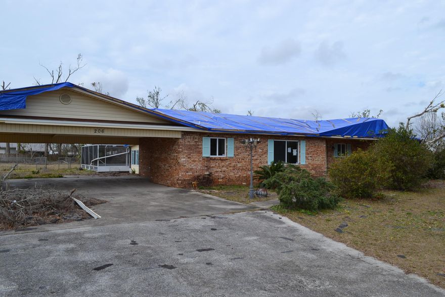 Brick home with lots of potential. Was damaged in hurricane. Home sits on almost an acre and features 3 bedrooms, 2 bathrooms, spacious living and dining area, kitchen with breakfast bar, Florida room, and in ground pool. Home is being sold as is, where is and no repairs will be made. This property is being placed in an online auction, the auction will begin 3/9 @ 8am and end 3/12 @ 2:30pm