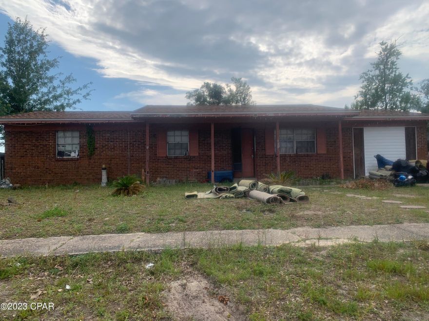 Great flip or rental property.  All brick three bedroom two bath ranch style home in Lannie Rowe Estates.  Home has good bones with a newer roof and hurricane clips.  However, home is very dated and will need to be remodeled.  Home features formal living room, eat-in kitchen and enclosed garage for an additional bonus room or 4th bedroom.  Enclosed garage could easily be converted back into a regular parking garage.  Home is high and dry and close to shopping, restaurants and Tyndall Air Force Base.  Only about a 25 minute drive to Panama City Beach.  Home is very dated and is in need of renovations.  There was a lot of debris left in the back yard that will need to be cleaned up.  Home currently has no carpet and will not pass FHA or VA financing.  Looking for cash investors.