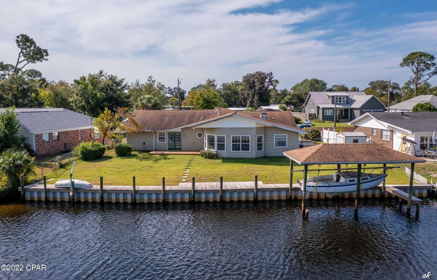 UNDER CONTRACT WITH CONTINGENCIES; SELLER ACCEPTING BACKUP OFFERS.

LOWEST PRICED BAYFRONT LISTING IN PANAMA CITY BEACH, FLORIDA!

The next Bayfront listing is $1.3 million and this one is ONLY $625,000 - show and make your offer today.  110 WATERFRONT FEET!

This home is located on a quarter acre lot which is very rare and nearly impossible to find in a waterfront lot in Panama City Beach.  Located right off of St. Andrews Bay with easy access to Shell Island and the Gulf (less than 12 minute boat ride to Shell Island).  Perfect for a family looking to get into a waterfront home for a very low price. Boasting 5 bedrooms / 2 bathrooms and 2500 square feet, this home is a dream and offers all the perfect features including large Bayfront windows and large porch area out back.  Bedrooms are private, open, and spacious and one of the bedrooms can be converted to an office.  An open living and dining area is located right off the living room and is perfect for family entertaining.  Some of the most impressive features of this home are the open porch and outside seating area off of the master bedroom, and newer dock and seawall (less than 2 years old), dock, and boat lift. 
You have to see this home and prepare to be in awe at the size and location of this home.  Also, be sure to check out the drone photography which highlights access to the Bay, Shell Island, and Gulf.