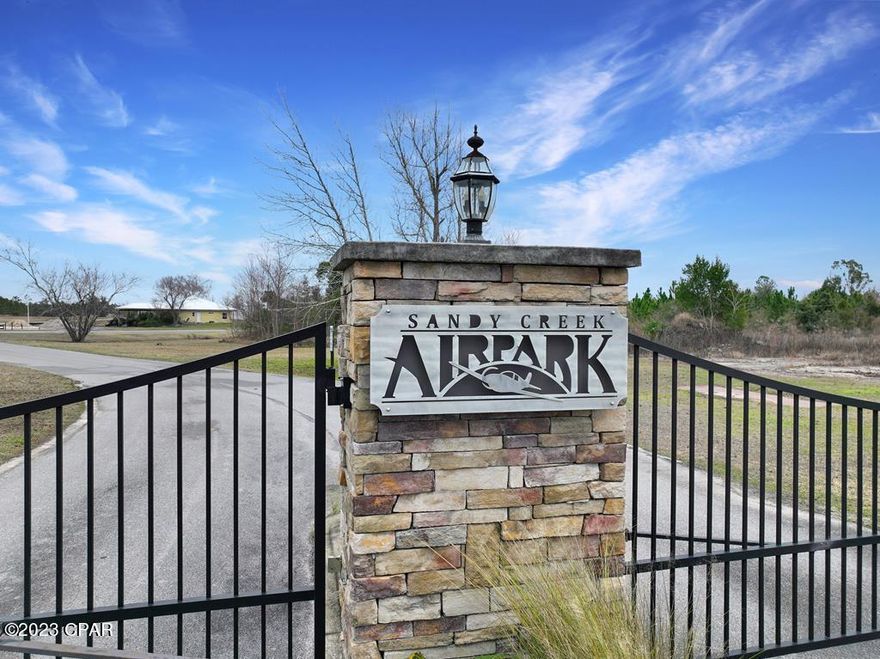 MAKE BAY COUNTY'S PRESTIQUOUS SANDY CREEK AIRPARK YOUR HOME ON THIS ¾ ACRE CLEARED READY TO BUILD LOT! Gated for privacy, Sandy Creek includes a community room & 3,200 ft. lighted & paved runway with a beacon for night flights. Covenants & restrictions are in place for architectural consistency along with underground utilities for aesthetic appeal. Add a private hangar to your design plans for easy access to taxiways. Reasonable HOA dues maintain the common areas along w/runway, roads, taxiways & easements. No flood insurance is required in the X Flood Zone. You will find the FAA airport designator 75FL located on the New Orleans sectional chart. Adjacent lot also available. This is the one you've been looking for! Don't delay! Call today for a showing & tour of the area.
