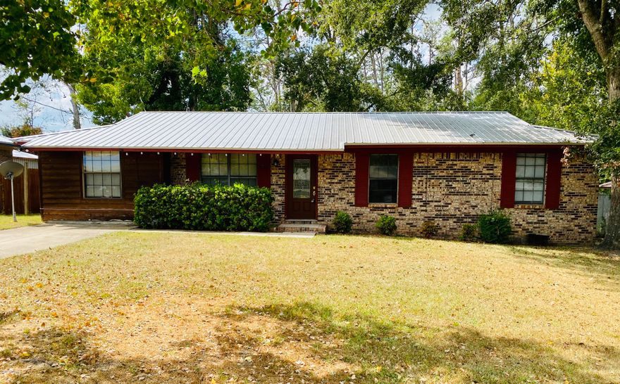 Brick Rancher close to downtown, three bedroom one bath with new metal roof. The orginal carport has been closed in, would make great den, office or 4th bedroom. Screened porch on back, has outbuilding has electric.