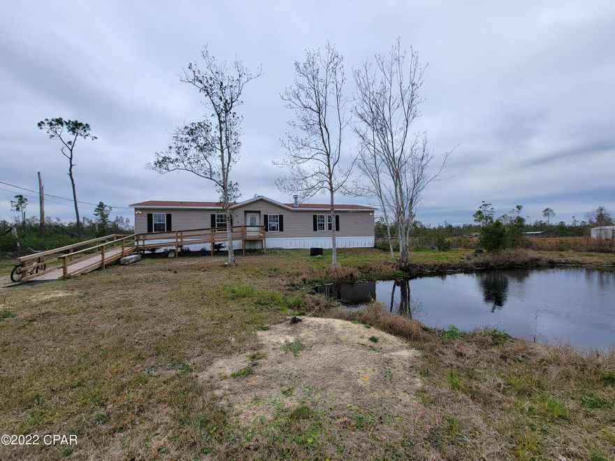 Make your appointment to see this home with over 2,000 square feet on over 1 Acre today! Featuring 3 Bedrooms & 3 Full Bathrooms plus a bonus room that could function as another bedroom or office, this home boasts a wide open living space with LVP floors & a wood burning fireplace. There are two Master Suites, with large walk-in closets. The main Master Bath has a separate Shower & Tub. Kitchen features all new cabinets & appliances are approximately 2 years old. New A/C in July 2020 & Roof in December of 2018. Nice Pond out front & solid ramp to the front entrance. Off the kitchen & laundry room is a side porch & partially fenced yard for the pups. Owner is finishing up some interior remodeling including paint, trim, etc. but encourages all offers if you want to finish it up yourself!