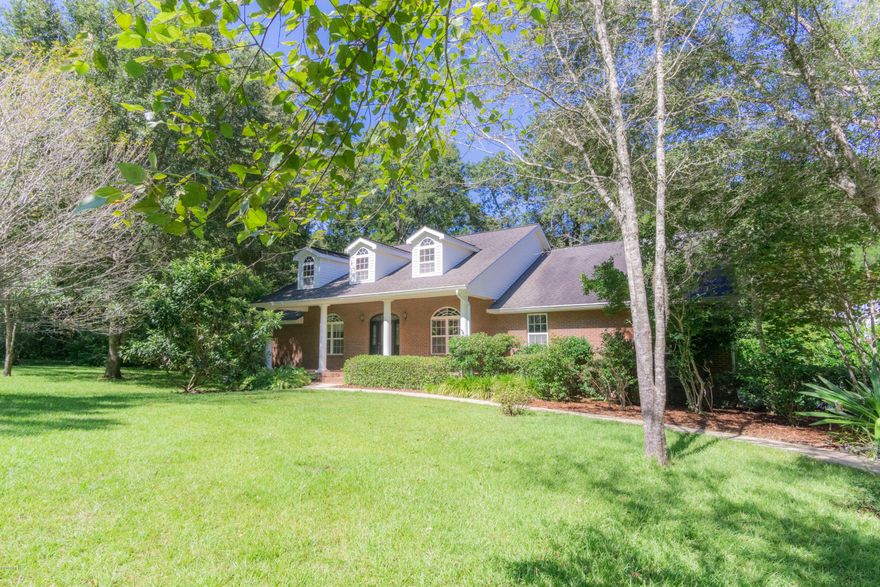 Wonderful Custom Built Home (Guy Tatum builder) with so many extras. Solid wood front doors with side lights, covred front porch with room for a swing. As you enter Foyer have office on right (could be formal living area) and dining room on left. Great room with 10 ft ceiling and crown molding with wide baseboards and hardwood floors. Kitchen has abundance of cabinets, with pull outs and pantry space with eat in area. Split bedroom plan with master bedroom with large bath, 2 walk in closets. Additional 3 bedrooms and bath on opposite side of home. Nice size mud room with located near 1/2 bath. Back of home large sunroom that leads to covered porch. home has zoned Ac and extra insulation and is wired for back up generator. property has sprinkler system, 30x40 workshop.