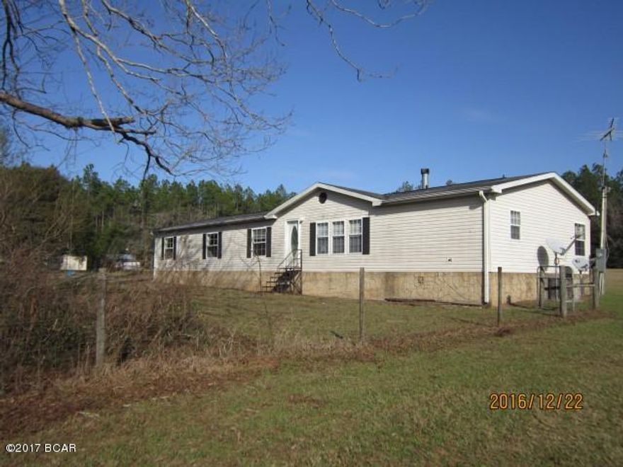 True modular home located in rural area on Hwy 73 near the Jackson/Calhoun County line, 15 miles S. of Marianna.  Feature a large kitchen and formal dining room, large living room with fireplace, family room with pass thru from kitchen (breakfast bar).  Home has split bedroom plan with Master on South end and three additionals on the North end.  The rear entry door from the utility room opens onto a 12 x 16 add-on porch.  New carpets in house, roof repaired and new paint where needed. Homesteps financing is available. Call your agent for details. Home marketed ''with repairs''.