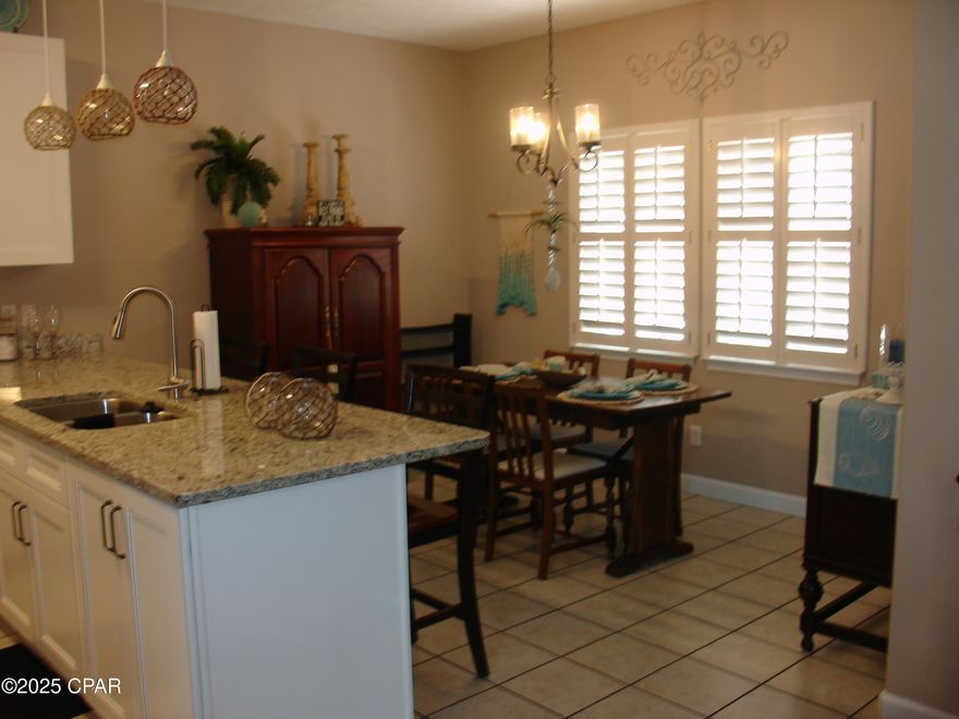 Beautiful Home on North Lagoon overlooking North Lagoon.  Only minutes away from the Panama City Beach, the World's Most Beautiful Beaches! As you step in, you'll immediately notice the open floor plan with a large living room, heighten ceilings giving it an open, airy feel downstairs, and tile throughout. The roominess of this townhome speaks for itself. Entertain guests and family in the beautiful kitchen open to the dining area. This kitchen has been recenty redone totally with new cabinets appliances and flooring.  It features new appliances and ample cabinet space for storage! Make your way upstairs to the main suite that offers a beautiful balcony that is perfect for watching that sun set across the sky! In the master bath you'll find double vanities, a nice stand-up shower, and a walk-in closet. Upstairs also features the additional two bedrooms and a full bath.  Also a balcony looking out over the back patio.  This home as had very recent updating of flooring, kitchen cabinets and counter tops and kitchen appliances.  Balcony off master bedroom looks out over North Lagoon. Nice back patio and storage room.  This has a roomy 1 car garage with extra storage space.