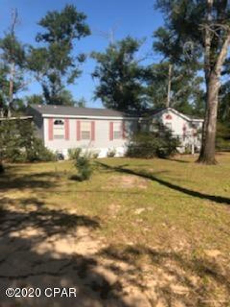 Great Starter home for someone on 1.25 acres.  This lot backs up to the Bay Line Railroad and has a small inground shelter.  This three bedroom two bath needs some work but is right off Hwy 231 and close to Compass Lake.  The outbuilding and some trees are down due to Hurricane Michael. The HOA fee is voluntary and gets you access to the community pool and lower fees for use of other community facilities. This will need to be a cash deal.  Being sold as is!