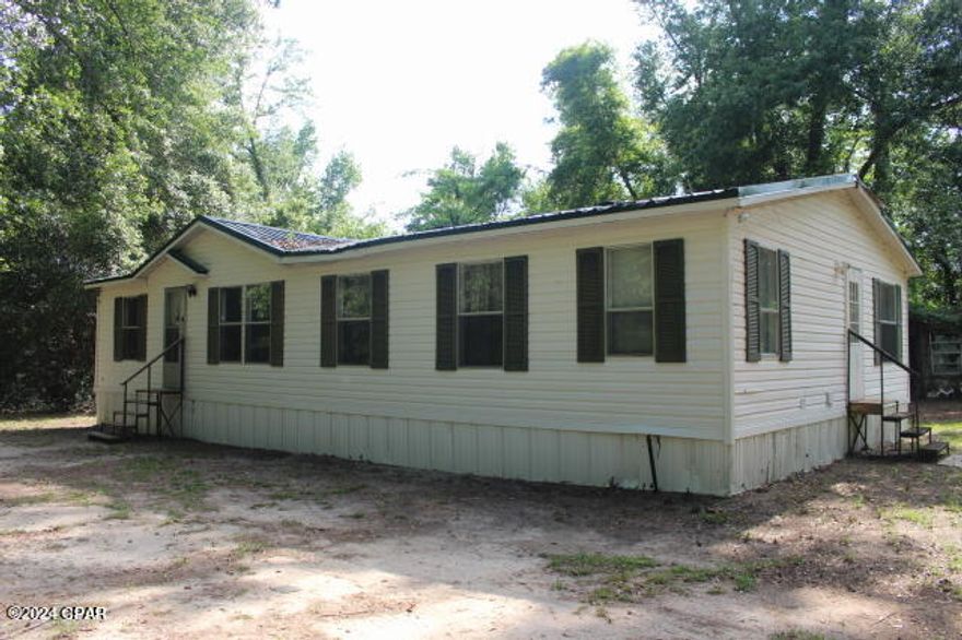 3/2 DW MH on 1 acre in a good location not far from town.  The property is shaded with oaks.  The MH does need wok but once the work is complete would be a nice home. It does need a HVAC system, floor covering, deep clean and appliances.  Bright Prospect Road is now paved.