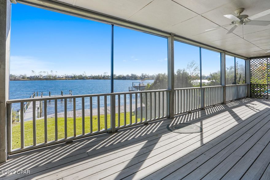 CURRENTLY UNDER CONTRACT, SELLER WILL CONSIDER BACKUP OFFERS. Panama Country Club is a community that offers the best of Lynn Haven, a private club, a golf course, and waterfront homesites.  This home was thoughtfully planned to enjoy the extensive views of St Andrews Bay and Beatty Bayou. From the secret garden entrance, the moment you enter the home the rich wood tones and breathtaking views will make this home a favorite for those who visit.  Spend less time commuting and choose to work from home or homeschool with just the right spaces designed for productive organization.  Then enjoy the rest of daylight playing golf, fishing, or watersports launched right off your dock!  The full-length screened porch is perfect for outdoor living space. Don't miss this home, you may not have a ... second chance as this home offers a lifetime of enjoyment!