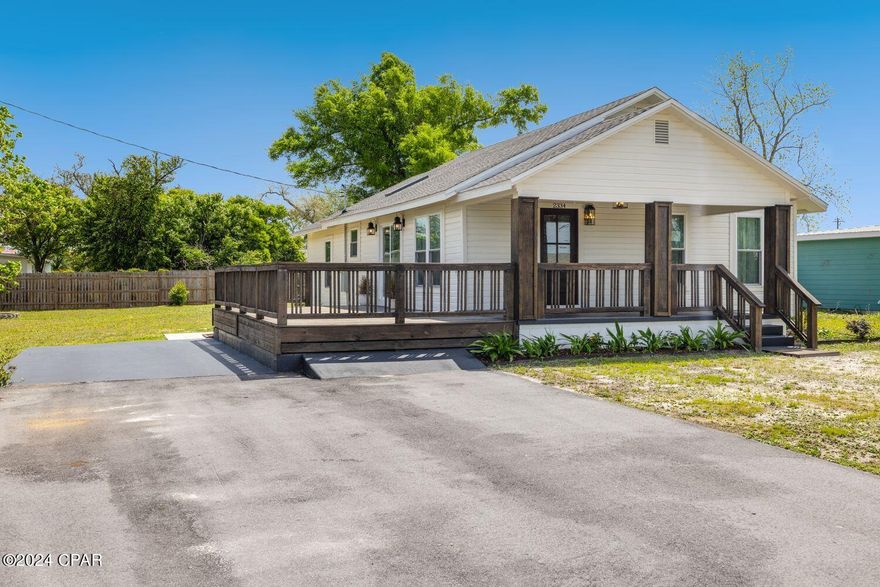 **CURRENTLY UNDER CONTRACT, SELLER WILL CONSIDER BACKUP OFFERS** Escape the hustle and bustle while still being just a stone's throw away from the sun-kissed shores of Panama City Beach. Nestled in a serene neighborhood, this meticulously renovated home offers the perfect blend of modern luxury and timeless charm.

As you approach, the eye-catching German woodlap siding and grand beams framing the wrap-around porch set the stage for what awaits within. Step through the inviting Mahogany door with privacy windows to discover a sanctuary where every detail has been thoughtfully curated to perfection.

Inside, high ceilings and refinished hardwood floors create an airy atmosphere, seamlessly connecting the open-concept living room, kitchen, and dining area. Bathed in natural light, this expansive space is ideal for gatherings with loved ones or quiet evenings of relaxation.

The kitchen is a chef's dream, boasting quartz countertops, a convenient island, and top-of-the-line Samsung appliances. A large skylight illuminates the space, while the Kingston aged brass pot filler adds both functionality and elegance. Beautifully crafted cabinets and an antique pantry provide ample storage, blending style with practicality seamlessly.

Explore further to find the first bedroom, complete with an antique closet, offering a cozy retreat for rest and rejuvenation. Nearby, a full custom bathroom awaits, showcasing a porcelain wall mural in the tile shower and marble countertop.

Continuing through the home, you'll discover a guest bathroom featuring a tiled shower, marble mosaic floor tiles, and a custom antique sink. Two additional spacious bedrooms at the rear of the house bask in natural light, offering comfort and tranquility.

Outside, the expansive .34-acre lot beckons with possibilities, whether you envision evenings gathered around the fire pit under the stars or envisioning your own private oasis with a pool or storage shed.

Experience the epitome of coastal living in this meticulously renovated home, where modern amenities harmonize with timeless elegance. Don't miss the opportunity to make this Bay County gem your own retreat.