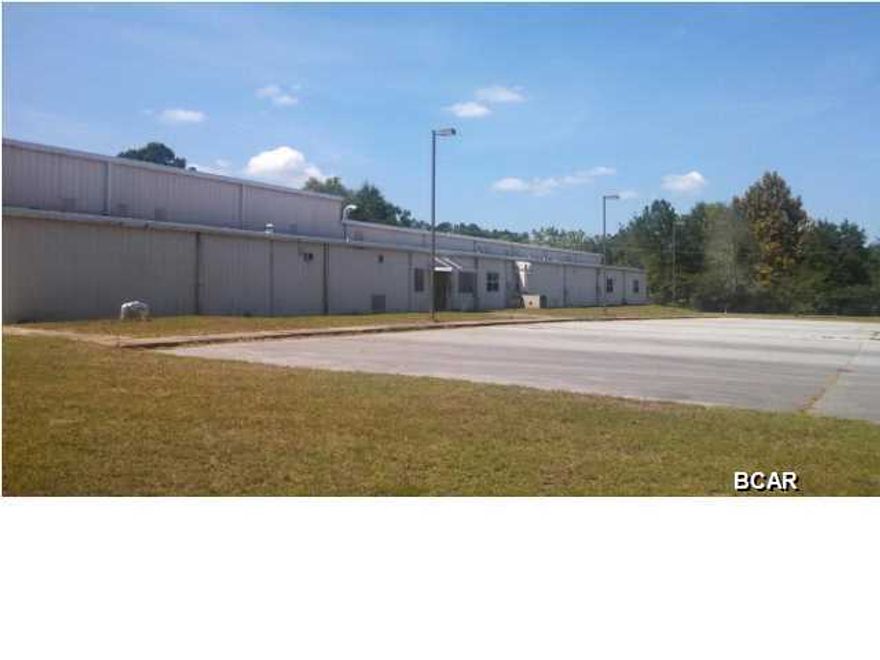 GREAT INVESTMENT OPPORTUNITY!!! Huge industrial building/warehouse located just a few blocks from Hwy 231 and only a few miles from I-10. Warehouse has office with pass through reception area, 3 large bay doors, loading and unloading area, 6 storage rooms, 2 bathrooms, and break room. Parking lot is paved and building is handicap accessible. So many possibilites. Possible Owner Financing!!!