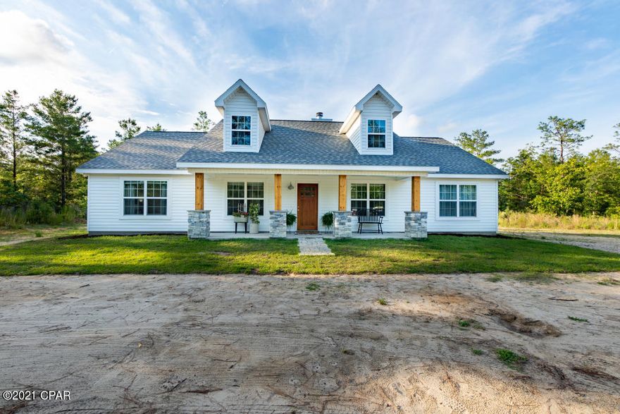 Don't miss out on this 2019, custom built, 4 bedroom, 2 bath, open floor plan farmhouse on nearly 10 acres. If you're looking for peace and quiet in the country, this is it. Located in the community of Grassy Pond Ranches, it's only about 30 minutes from Panama City and 30 minutes from Chipley. The community offers access to a pavilion area on Grassy Pond. This is 9.97 acres of beautiful, wooded property. The master bedroom features a shiplap accent wall, recessed lighting, a tray ceiling and sliding barn door. The large master bath has a beautifully tiled walk in shower with double rain heads, a shiplap accent wall, his and her walk in closets and plenty of additional storage with a large linen closet and a spacious vanity. With 3 additional bedrooms, this home is perfect for families looking for space to accommodate or the ability to have a exclusive office space for those who work from home. The living room showcases a German Schmeared brick wood burning fireplace that meets up to a shiplap accent, as well as cathedral ceilings that continue into the dining and kitchen area. The kitchen includes recessed lighting, upgraded stainless steel appliances, a subway tile backsplash, and a large pantry. Mounted TV's and all appliances are included to the buyer.