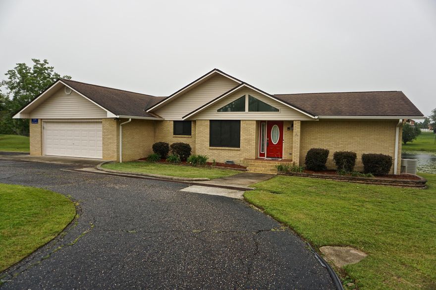 CURRENTLY UNDER CONTRACT, SELLER ACCEPTING BACKUP OFFERS'  Beautiful waterfront home in quiet subdivision in Marianna. This 3 bedroom, 2 and a half bathroom home is located in close proximity to Citizen's Lodge, Marianna High School, Marianna K-8 school, Jackson Hospital, and local shopping. The open-floor plan home features a gas fireplace and cathedral ceilings in the living area offering plenty of natural light. In the kitchen there is a breakfast bar close to dining and living areas. Double doors lead from the living area to the large back deck overlooking the peaceful spring-fed lakes in the backyard full of lily pads and wildlife. This is a perfect setting to enjoy your morning coffee or grill and entertain guests for seamless indoor to outdoor living. The spacious master bedroom is The master bathroom features a walk-in closet, double vanity, tiled separate shower, jacuzzi tub, and bidet. The living areas have new vinyl-plank flooring and have been freshly painted. The carpet in all of the bedrooms will be replaced soon. The home has plenty of storage in pantry/laundry room, and attached two-car garage. The garage has build in cabinets and a half bathroom. There is also a storage room/walk-in basement with access on the back of the home. The home will come with a Ring doorbell security system, and wifi controlled thermostat and garage door opener. There is also a termite bond with Terminix.