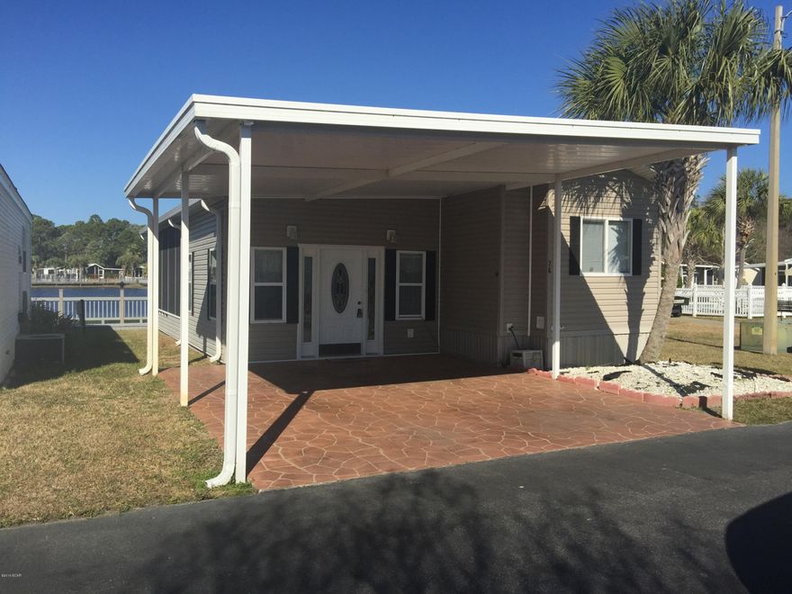 Perfect Get-Away!  This is one of the largest homes available and is in the most desirable location.  Plenty of space for family and friends to gather on the back patio overlooking the pond, or step out onto the dock and feed the turtles.  Just steps to the pool and facilities as well.  Large Master and guest, and plenty of storage space available in this very clean unit.  Great Investment Property and is a very popular Rental.