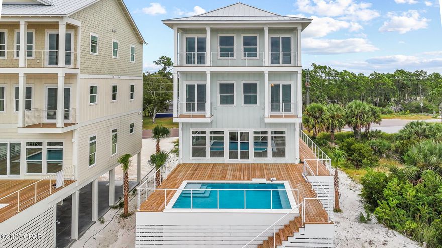 ULTIMATE GULF FRONT HOME! Nestled on pristine Gulf front sand, 295 Watermark Way offers the ultimate coastal escape-where turquoise waves, sugar-white beaches & unforgettable sunsets set the stage for lifetime memories. This brand-new custom beachfront build, within the serene lower-density stretch of St. Joe Beach, effortlessly combines luxury, comfort & coastal charm. With six beautifully appointed suites, this home is perfect for multi-family vacations or large groups seeking space, style & shared experiences. Each beachfront king suite opens onto its own deck, allowing you to  awake to sea breezes and Gulf views. The homes best feature is a private heated pool just steps out the door to be enjoyed year round. The soaring open living spaces, gourmet kitchen & soft coastal finishes evoke easy elegance. The layout is designed for joyful mingling where you enjoy panoramic Gulf vistas from every level & wide decks that connect you to the horizon. An elevator provides smooth access across all floors. Beyond the walls of this spectacular home, you'll find immediate access to the Gulf with a private boardwalk & steps to powdery sand.   Hop in your golf cart or go for a peaceful bike ride along the paved paths to Windmark Beach where you will find fun, food, and entertainment for the whole family.   A short ride into Port St Joe connects you with  boutique shopping, fresh seafood restaurants, a bustling marina, and a charming historic district. Whether you're planning an epic family retreat, a generational reunion, or a carefree getaway with friends, this home is built to host in style. From sunrise yoga to cocktail hour on the deck, to late-night stargazing by the sea—every moment unfolds with elegance and ease. Call for your private tour & LIVE THE BEACH LIFE!