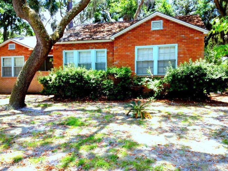 PICTURESQUE HOME in POPULAR COVE SETTING maintains much of its ORIGINAL and VINTAGE CHARM. INTERIOR FEATURES include some HARDWOOD and TERAZZO FLOORING, A WINDOW SEAT in a FRONT-FACING bedroom, and PERIOD INTERIOR DOORS. Formal dining and living spaces and a LARGE ENTRY HALL with CHANDELIER are at the front of the home.  The bedrooms are designed in a SPLIT FLOOR PLAN; GREAT FAMILY SPACES include a LARGE FAMILY ROOM. The OPEN kitchen is equipped with a GAS STOVE, oak cabinetry, and a BREAKFAST BAR. These GENEROUS SPACES lead to the REAR PATIO and SHADE-FILLED YARD.  The LARGE LOT features a DOUBLE CARPORT, and the FENCE has a GATE that can be accessed by the CONVENIENT SIDE ALLEYWAY. Curb appeal, SPACE, and personality all dressed up in BRICK define this DELIGHTFUL COVE SETTING.