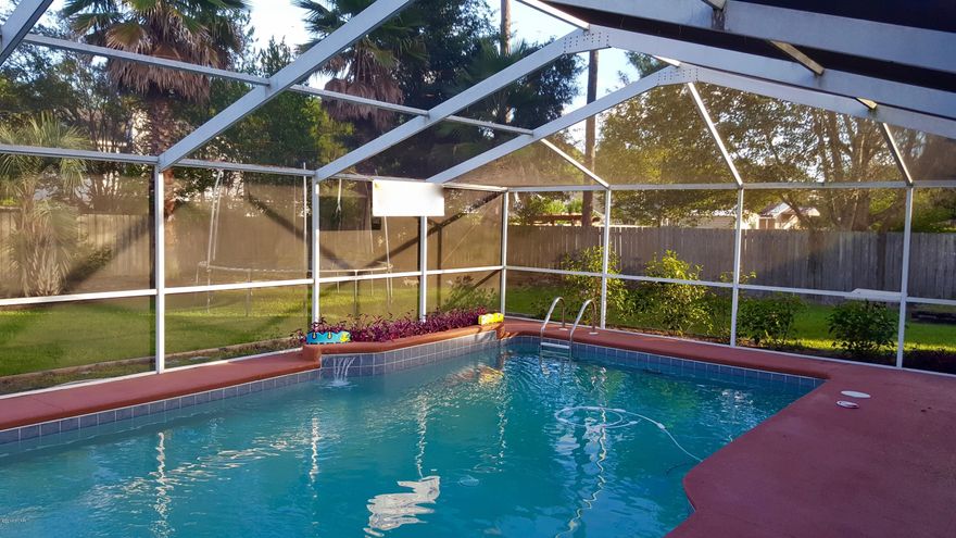 Come see this outstanding pool home in a quiet and desirable neighborhood on the east side of Panama City. Located near shopping, churches, parks, recreation and a short distance to Tyndall Air Force Base. Good schools as well as close proximity to Bay Haven Charter Academy.  The home is a contemporary style, slab on grade with brick and Hardiboard siding. There are numerous upgrades and the home is in good condition. The kitchen has nice appliances including refrigerator, range, dish washer, disposal, microwave and hood. It is a 3 bedroom 2 bath home with upgraded bathrooms containing granite tops and cabinetry.  (please click more) The home has berber carpet and ceramic tile flooring throughout. With an invitingly open plan you have a great view of the screened pool from inside.  The pool deck is totally screened-in with a waterfall feature providing a perfect oasis. The home's A/C has been replaced in recent years. It has a wonderful privacy fenced back yard with a built-in play area with a kids fort and slide. The yard is nicely landscaped with a well and sprinkler system.  This property has NO HOA and is NOT in a flood zone.