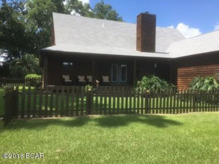 Beautiful country estate just outside city limits! Mature pecan trees, young peach trees, pear trees, citrus trees, grapevines and blueberry bushes.  Pond for fishermen with bass and catfish.  House has new roof and both heat pump units replaced this year.  Very private location. Property is located 45 minutes from Panama City.
