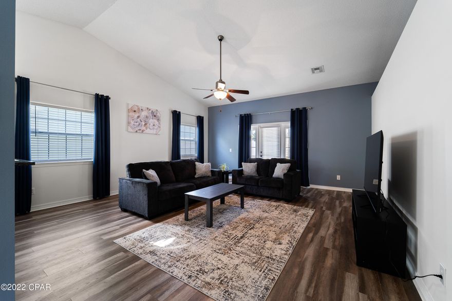 Here is your chance to own a well-maintained 3 BR, 2 BA home in the desirable neighborhood of Palmetto Trace. The recent updates include a new roof in 2020, luxury vinyl plank flooring, and privacy white vinyl fence. The kitchen features stainless appliances, granite counters, great cabinet space w/ a separate pantry. There are vaulted ceilings and a built-in drop zone for convenient storage in the living room. The master boasts plenty of room for a King bedroom suite and double French door access to back patio. Master bath includes two walk-in closets, double vanity, and jetted tub/shower. Palmetto Trace offers two community pools and golf cart proximity to the beaches, Pier Park shopping and dining, and Frank Brown Recreational Park. Call today for a showing! *Room measurements are approximate, please verify if important.