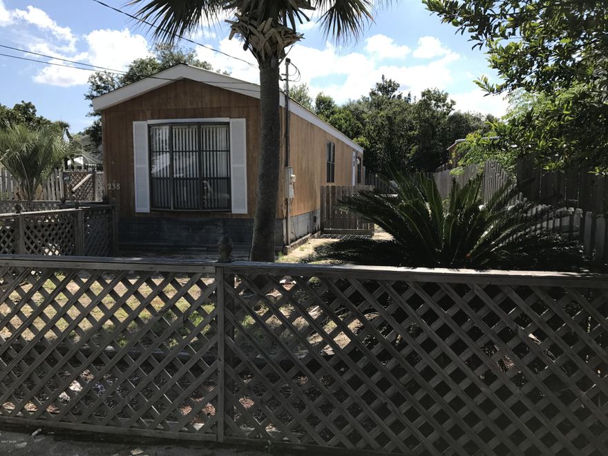 Nice single wide home only one and a half blocks to the beach! This affordable home is close to Pier Park and ''The World's Most Beautiful Beaches''. Enjoy the open front porch and the quiet setting of this nicely landscaped yard. Great condition, new carpet in living area and new vinyl floors in kitchen and bathroom. Property comes with 2 storage buildings, one storage building can be used as Car/golf cart or boat storage. Call Roswitha 850-814-9337. Outside shower and back deck.This home has been very well maintained including fenced in lawn and a large drive way.Cash only