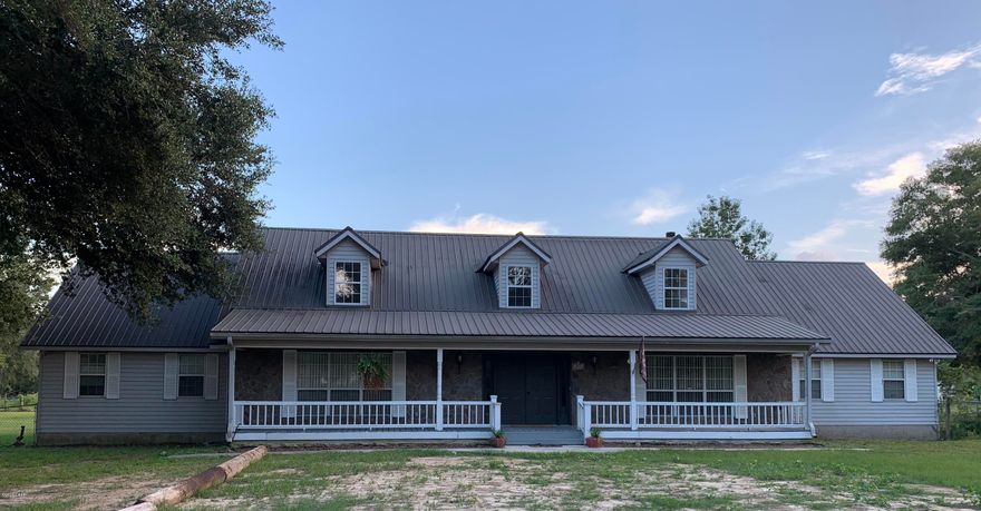 Enjoy cool mornings and quiet evenings sitting on the front porch of this sprawling 4876 square foot(3485 heated/cooled) country home.  This 4 bedroom 2½ bath home was built in 1990 and is situated in the middle of 5.3 acres on Fort Rd/Hwy 69 just 2 miles outside Greenwood's city limits and less than 10 minutes from Marianna schools.  There are plenty of indoor and outdoor living space to accommodate a large family and unsurpassed storage space with 11 closets downstairs and 8 closets upstairs including two walk-in 17ft x 13ft attic spaces.  The two car garage is accessed from the back of the home, keeping the façade uninterrupted and the mature oak trees on this property add a touch of Southern charm.  The American dream awaits!