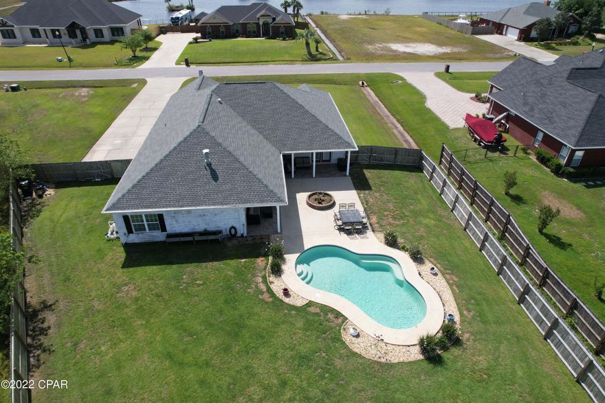 Huge lot! Inground pool facing the small lake where jet skis are permitted! 4 Bedrooms and 3 baths with 3 exits to the back yard. Fire pit- Custom cabinetry- kitchen island with breakfast bar- Fire place- Double garage!- Room for a motor home in back yard behind the gate!  2 living areas!  Separate dining area! Fenced yard!

It truly checks all the boxes, especially since the HOA is only $175 PER YEAR--- which means not even $20 a month!