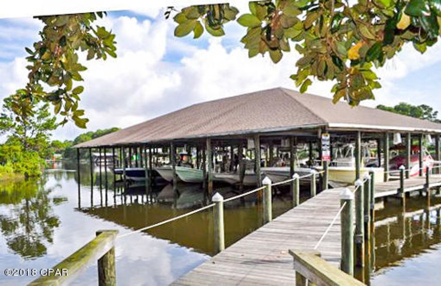 Make this adorable 2BR/1.5BA townhome style condo yours before it's gone! Availability to have personal boat slips on the lagoon with access to the Bay and Gulf. Kitchen oversees the living room area for easy entertaining! Bedrooms are upstairs with upstairs laundry! Private back balcony overlooking the pond. One car garage and one car space unit. Bonita Point boasts a sparkling pool and clubhouse. Walking distance to the beach, and close to St.Andrews state park,shopping and restaurants.The complex has a dock and boat slips as well.