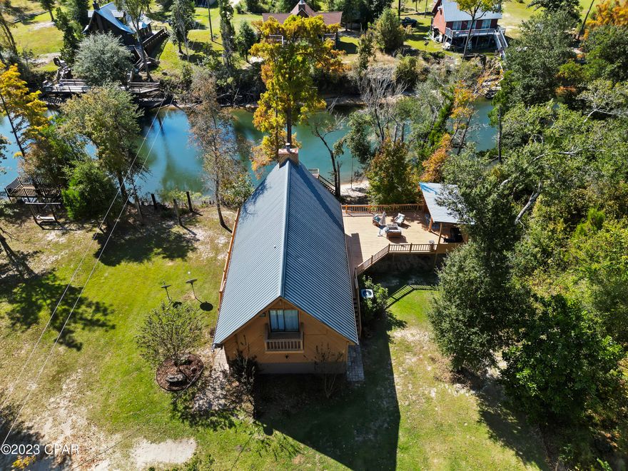 This is the perfect river house with a pool!  Never lose access due to river rising.  Bank has beach access to water.  This river is perfect for fishing, kayaking, lazy river floats, or just sitting on the large deck and enjoying what this slice of heaven has to offer.   This home has several updates:  HVAC and metal roof have been replaced in the last five years.  New appliances and windows within the last year.  New Shaw flooring in downstairs.  Great location for peace and tranquility. One hour to the world's most beautiful beaches, 20 min. to Marianna and 10 min to Blountstown.   Come wake up on vacation every morning!