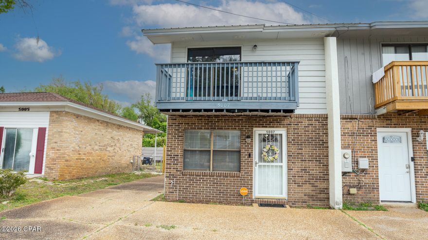 Close to Tyndall this Amazing townhome is 2 BR/2.5 BA end unit and comes with extra driveway space that goes to detached 2 car garage, large U-shaped lot with privacy fence in back yard and no HOA fees.  Great for primary home or rental investment as a short- or long-term rental.  Living room, kitchen and dining area, plus the laundry room and a half bath on first floor. The kitchen is updated with stainless steel appliances, granite countertops, tile backsplash, sliding door to walk out to nicely landscaped back yard.  Tile flooring throughout the downstairs. Upstairs, you will find two large bedrooms, each with private full bathrooms.  Master suite features a balcony with a beautiful water view of Pitts Bayou.  Furniture does convey. Conveniently located near Tyndall Air Force Base, Mexico Beach, shopping, schools, parks, boat ramps, and much more! Dimensions are approximate.