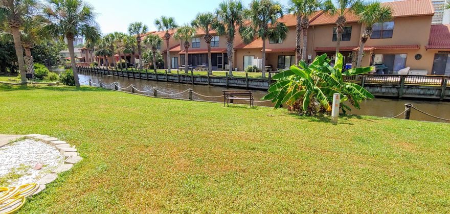 If you are L@@King for a Cute & Beachy Townhouse with 2 Bedrooms + Extension & 2.5 Baths ON THE CANAL located in a Gated Resort that is WALKING Distance to the BEACH... Here it is! ''Leisurely Fish'' in YOUR back yard. The HOA Dues are only $450 a Quarter NOT a Month and that pays for your  Basic Cable Package, Termite Bond, Household Trash, some Pest Control, Mowing your Lawn, and Lots of Amenities. Speaking of Amenities, there are 11 Pools ''5 Heated'', Shuffleboard Courts, Tennis Courts ''2 Lighted'', an 18 hole Mini Golf Course, Conference Center, Fitness Room PLUS there is a Private Clubhouse with a Snackbar and a Pool directly on the Beach and it is also ''Gated''!!! There is NO Extra Charge to use the amenities.  Age, SF, and Dimensions are approximate... please verify if important.