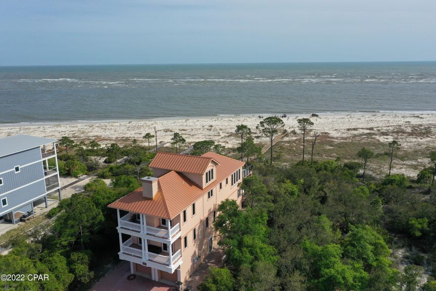 This beachfront home is 1 of the premier homes on Indian Pass or Cape San Blas. This 1 owner home was built in 2008 with no expense spared. Over 7,200 total sq ft w 4,185 h/c built for executive style luxury. Tons of great common areas loaded with extras. Big 2 car garage, spacious cedar closet plus tons additional storage on ground floor with elevator. Huge master plus 3 bedrooms and 2 baths on next floor. Massive 3rd floor with a great sitting area w/fireplace on back of house & half bath, facing the beach w/unbelievable views is one of the best living/kitchen/dining rooms you will find anywhere. Custom cabinets, sub zero cabinet style fridge/freezer, very open trayed ceilings with unbelievable trim work, large beach view patio, 4th floor observation area w/amazing views could be a good game room or reading area. Furniture is included.