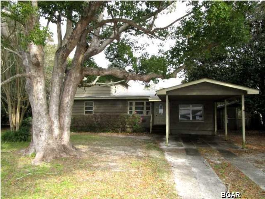 GREAT PRICE REDUCTION ON THIS TWO-STORY HOME WITH A POOL NEAR TYNDALL AFB! This home has a lot of space with rooms that include a kitchen with some updates like kitchen cabinets, counters and appliances; a living room open to the kitchen; an enclosed garage that is now a large Den; and an additional room off the back of the home that would be a great recreational room. There are two bedrooms with hardwood floors on the main level, along with a full and half bath. Two additional bedrooms are on the second floor. From the recreational room, you can access the covered patio that overlooks the in-ground pool. Home has a carport and a yard building for extra storage. Home is being sold in its AS IS condition.  BRING ME AN OFFER!!