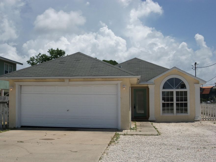 Great 3 bedroom, 2 bath house just 4 blocks from the Gulf. This contemporary beach house features a large great room with fireplace, open floor plan with plenty of storage in the kitchen, split bedroom with the large master suite at the back of the house overlooking the charming back yard. Large back covered patio could be very easily screened in. Landscaping rocks minimize yard work! No HOA fees makes this a great vacation home or primary residence! Don't miss it! Auction property. (all sizes approximate and taken from public records, buyer to verify any details that buyer deems important).