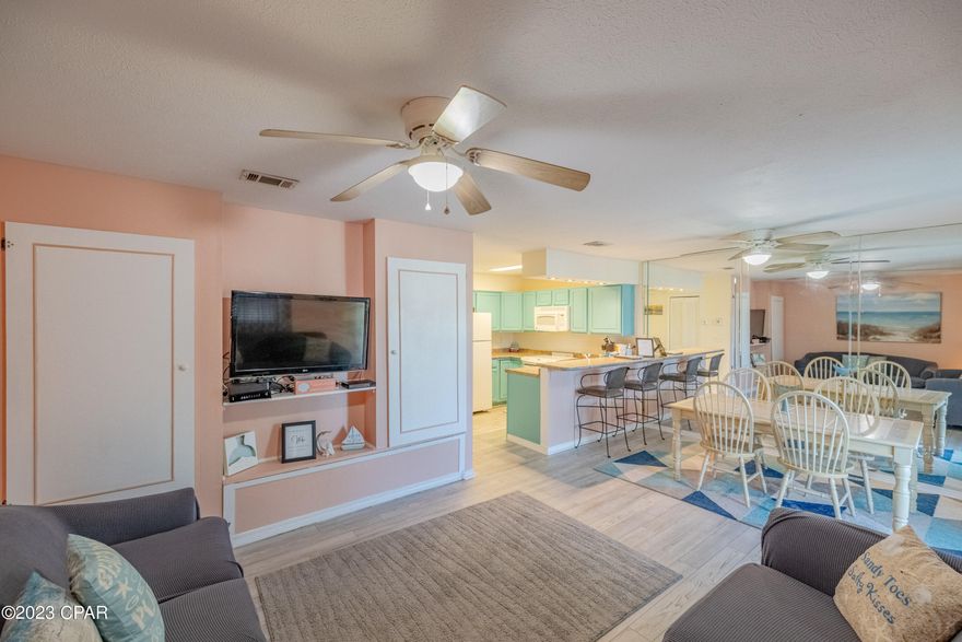 CURRENTLY UNDER CONTRACY.  SELLER'S WILL CONSIDER BACK UP OFFERS.  FIRM!   All furniture except outside furniture.  Beautiful condo that has been refurbished.  Unit has Luxury Vinyl Plank flooring throughout.  Beachy interior theme.  The gas stove has been replaced with a glass top electric stove. Built in microwave replacing the stove hood.  Hot water heater, 2 yrs. old.  Recessed lighting in the kitchen and bar area.  2 upgraded sofa sleepers  in the Living room , replacing the daybed.  Upgraded furniture throughout and a practically new washer and dryer which is full size.  This unit is immaculate and ready to move in.  It also features a balcony which is shaded in the evenings.  There is plenty of closet and storage space.  Dues include the Insurance water and Sewage ,Pest control and cable.  This is cheaper than if you had to buy it separately.  The complex is as a gated community with 11 swimming pools, (5 heated), and one on the Gulf side behind the clubhouse and restaurant. 4 tennis courts(2 lighted at night).  A 2 acre miniature golf course. Owner's pets allowed. This is one of the least expensive condos you can buy in Panama City Beach which is walking distance to the beach.  Must see this one before you buy!